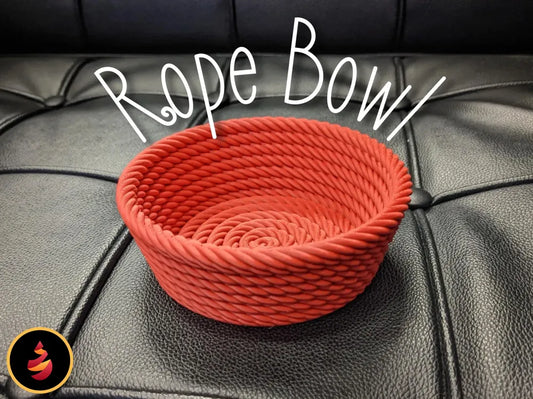 Red 3D-printed rope bowl with tight weaving on black surface
