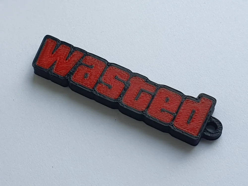 3D printed 'wasted' keychain with red letters and black border