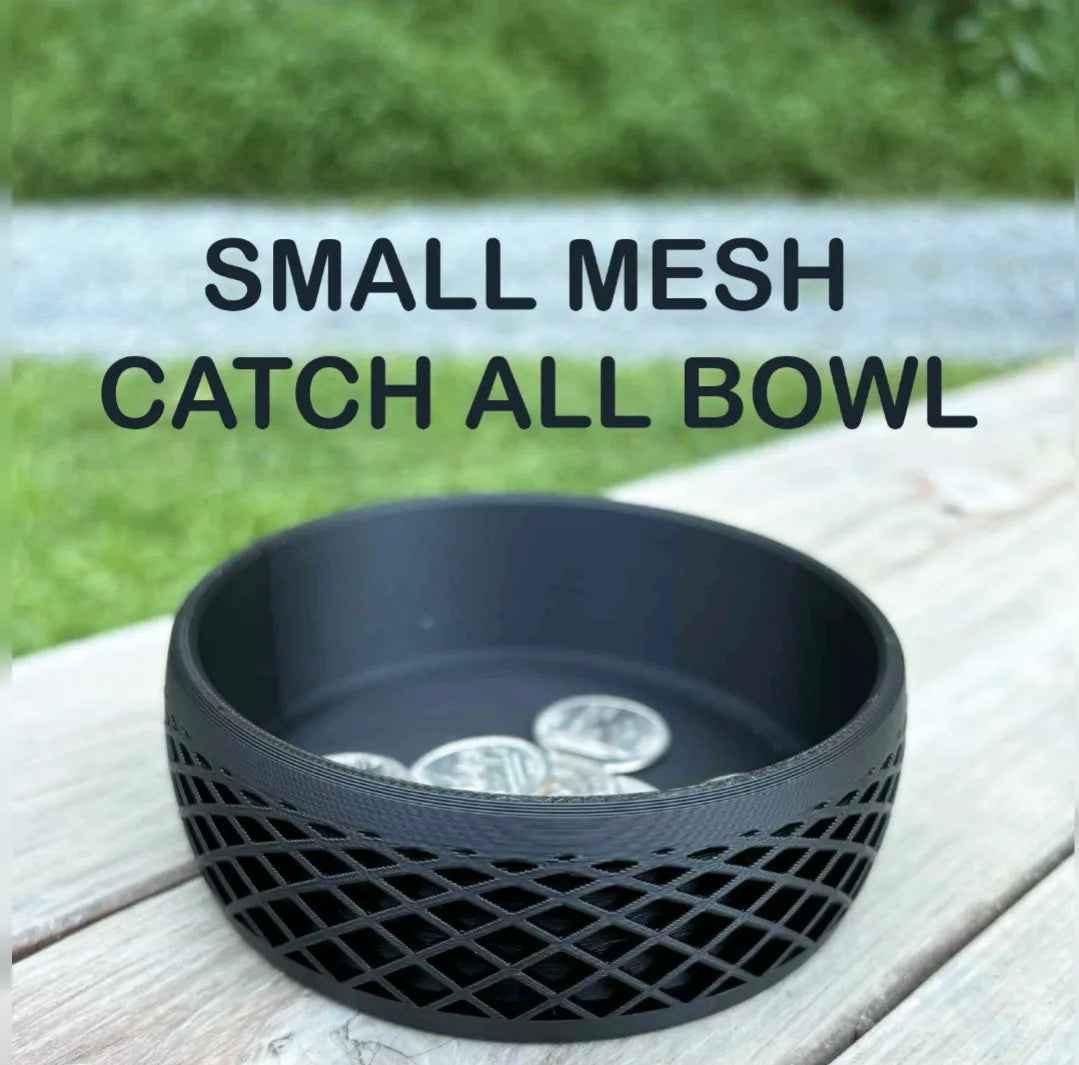 Small black mesh catch all bowl on wooden surface with coins inside