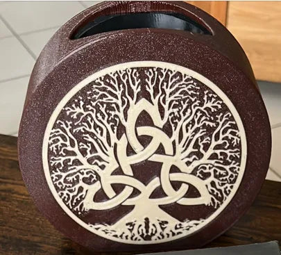 Tree of Life decorative vase with intricate white tree and knot design on brown background